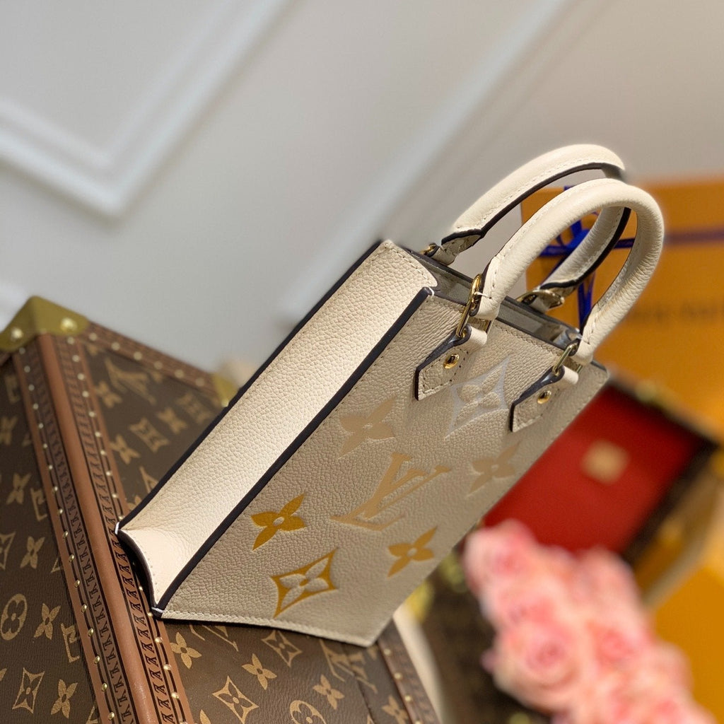 LV PETIT SAC PLAT CREME MONOGRAM EMPREINTE RINDSLEDER