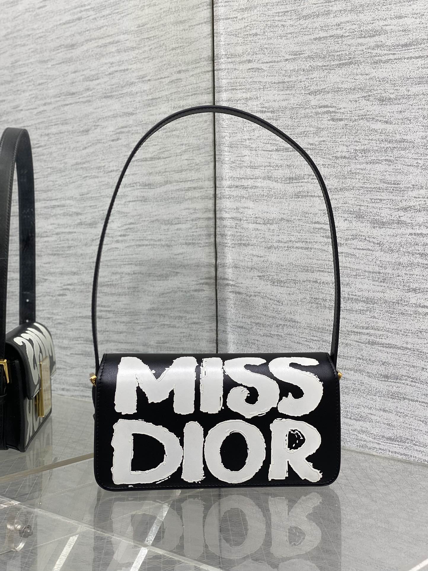 KLEINE 22-KLAPPENTASCHEN AUS SCHWARZ-WEISSEM LAMMLEDER MIT GOLDENEN BESCHLÄGEN